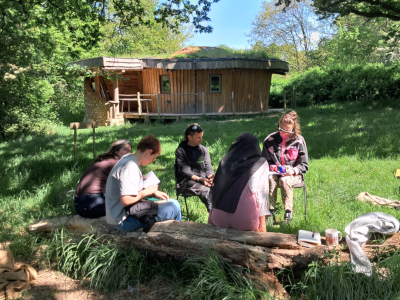 students with woodland classroom in the background